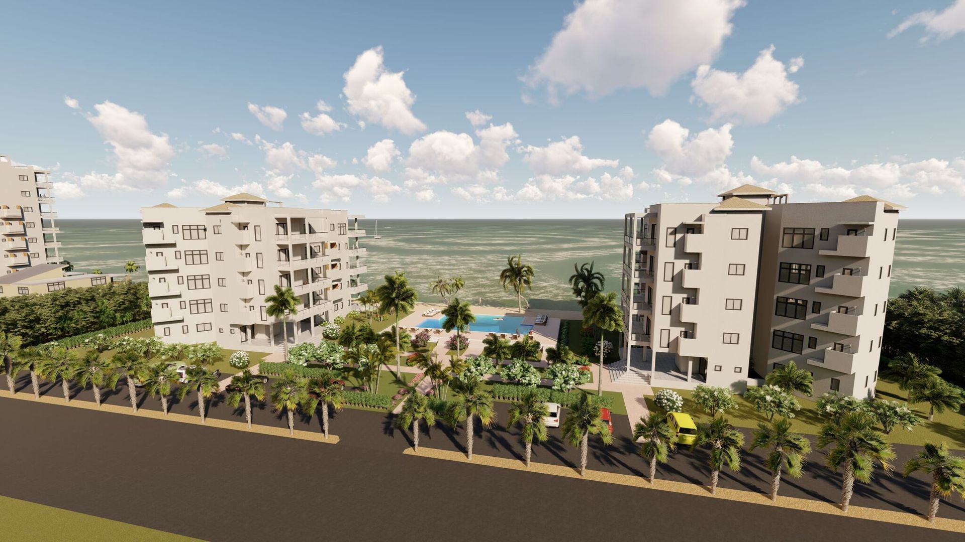 Two apartment buildings with a pool and palm trees near the ocean on a sunny day.